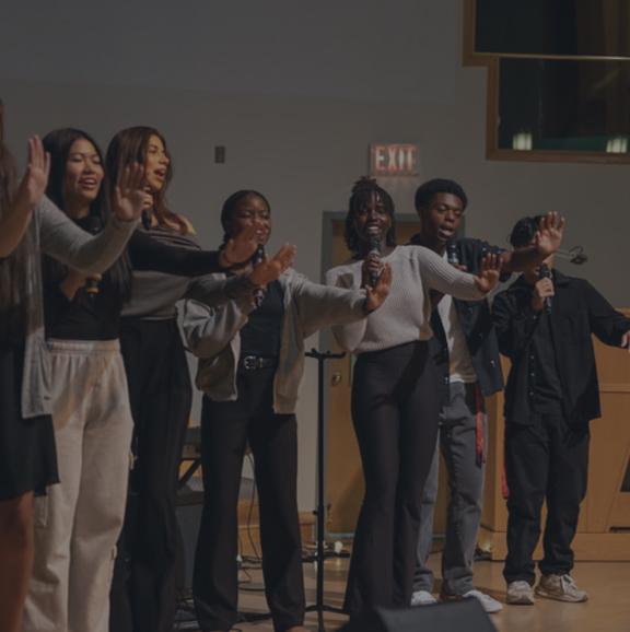 Students singing on stage